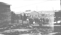 Listening to a speech in front of the Community Hall